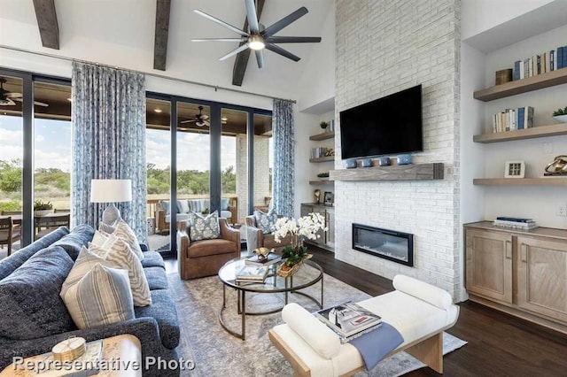 living room featuring beam ceiling, a fireplace, a towering ceiling, and dark wood-type flooring