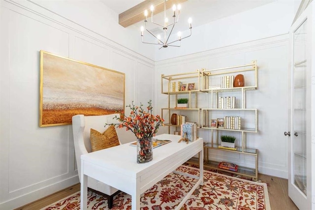 home office featuring beamed ceiling, wood-type flooring, and an inviting chandelier