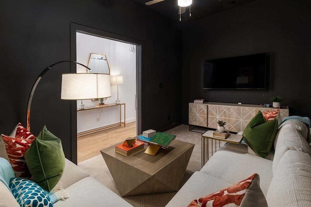 living room with ceiling fan and wood-type flooring