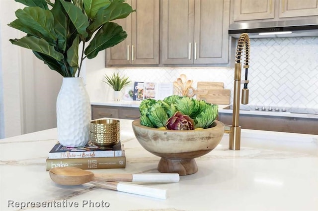 interior details with backsplash and light brown cabinetry