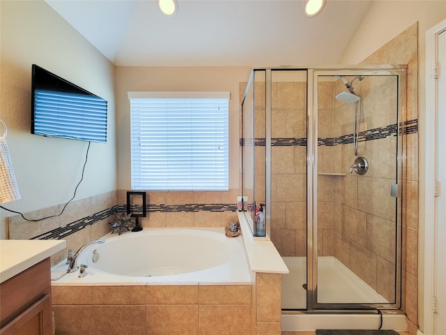 bathroom featuring vanity and independent shower and bath