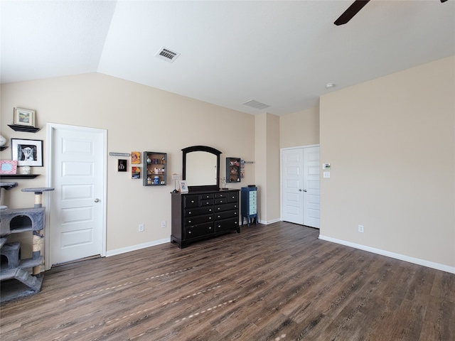 bedroom with ceiling fan, lofted ceiling, and dark wood-type flooring