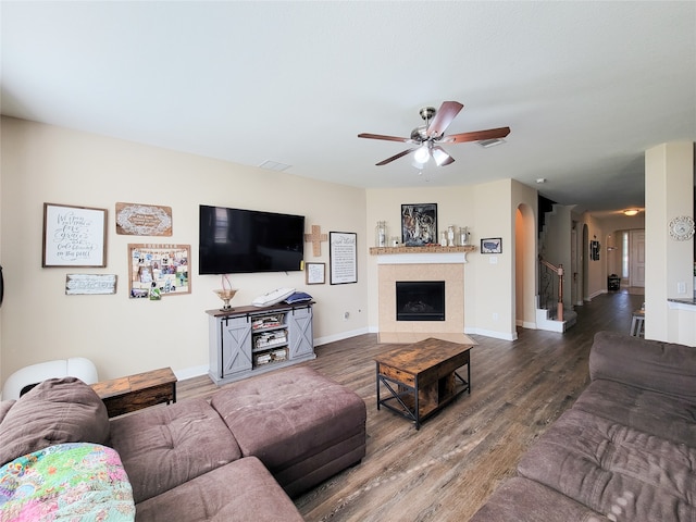 living room with ceiling fan and dark hardwood / wood-style flooring