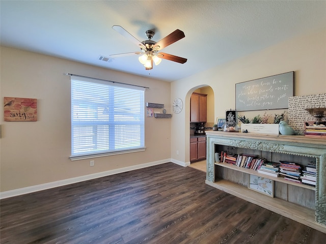 interior space featuring ceiling fan and dark hardwood / wood-style flooring