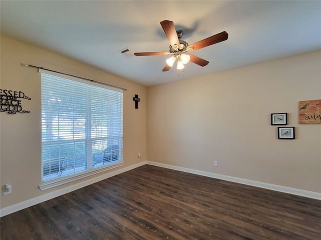 empty room with ceiling fan and dark wood-type flooring