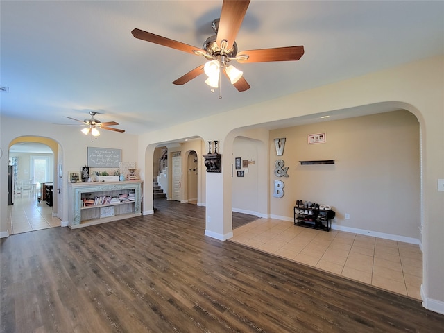 unfurnished living room with hardwood / wood-style floors and ceiling fan