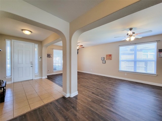 foyer featuring ceiling fan, a healthy amount of sunlight, and hardwood / wood-style flooring