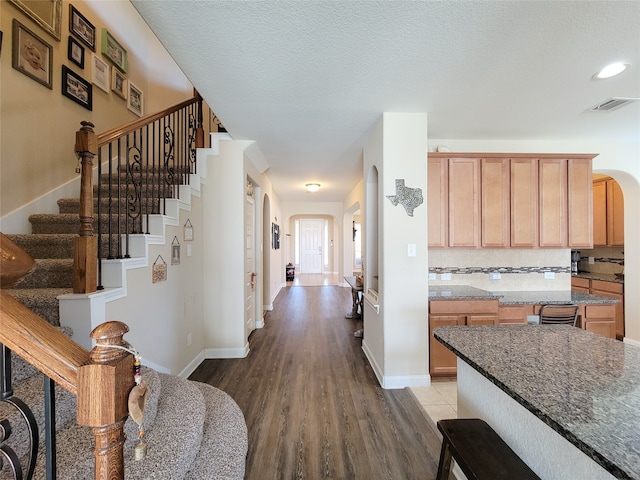 foyer with wood-type flooring and a textured ceiling