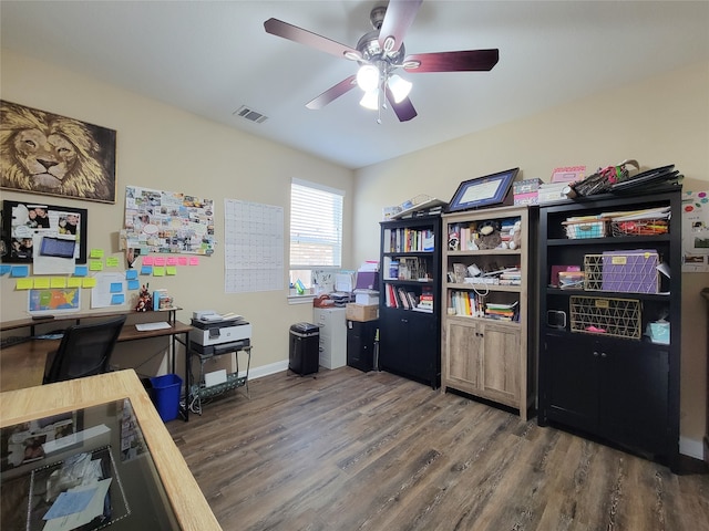 home office with ceiling fan and dark wood-type flooring