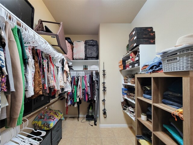 spacious closet featuring light tile patterned floors