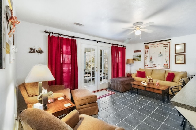 living room featuring dark tile patterned flooring, ceiling fan, and french doors