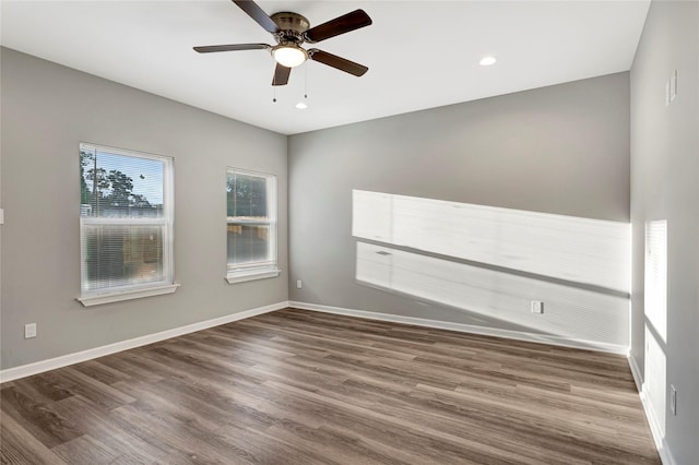 spare room with ceiling fan and wood-type flooring