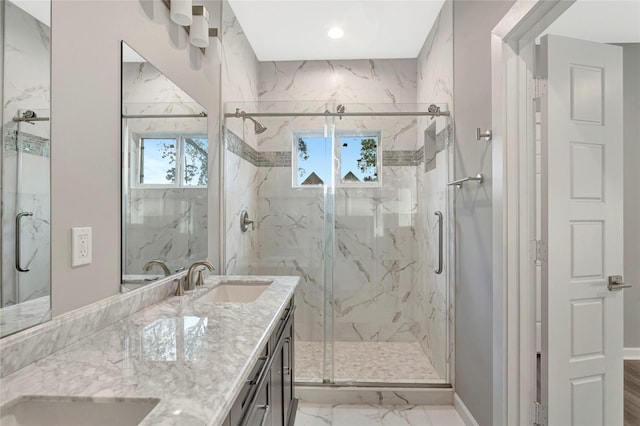 bathroom featuring vanity, a healthy amount of sunlight, and walk in shower