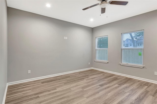 spare room with ceiling fan and light hardwood / wood-style flooring