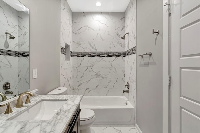 full bathroom featuring tiled shower / bath, vanity, and toilet