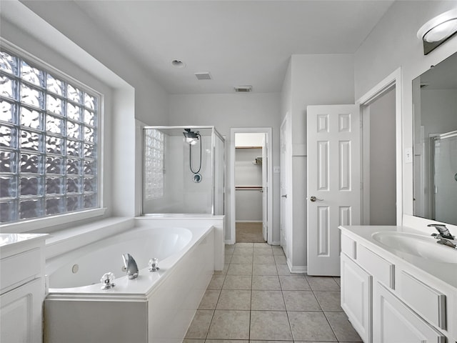 bathroom featuring tile patterned flooring, vanity, and separate shower and tub