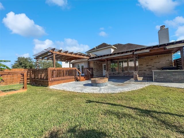 rear view of house featuring a lawn, a pergola, a patio, and a deck