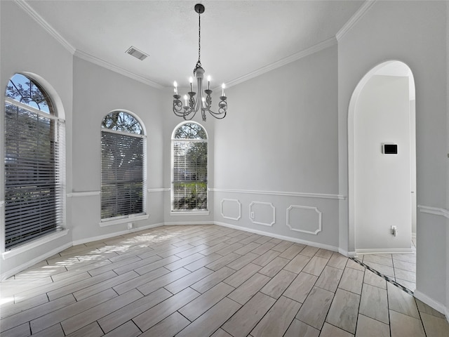 interior space featuring light hardwood / wood-style flooring, a chandelier, and ornamental molding