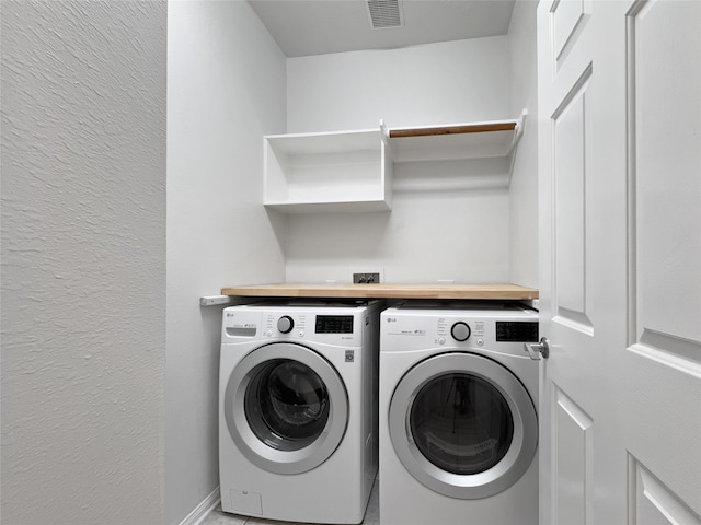 clothes washing area with separate washer and dryer