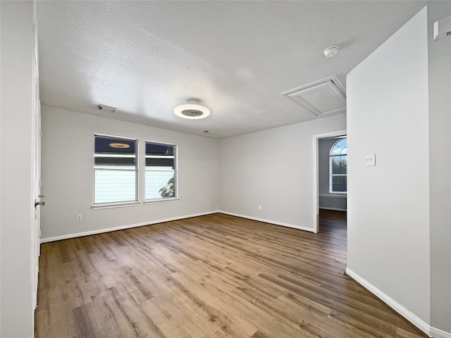 empty room featuring hardwood / wood-style floors and a textured ceiling