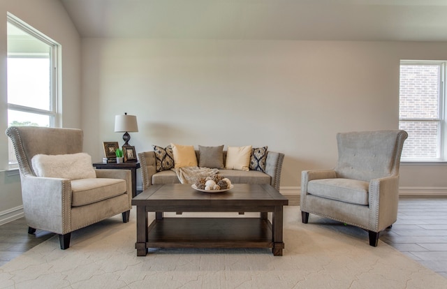 living area featuring lofted ceiling and light wood-type flooring