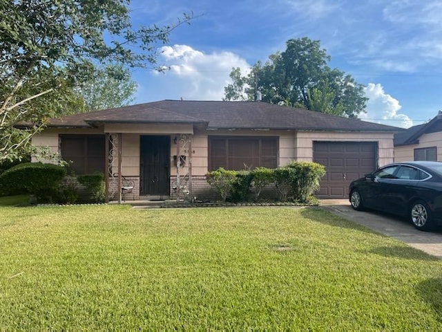 single story home featuring a garage and a front yard