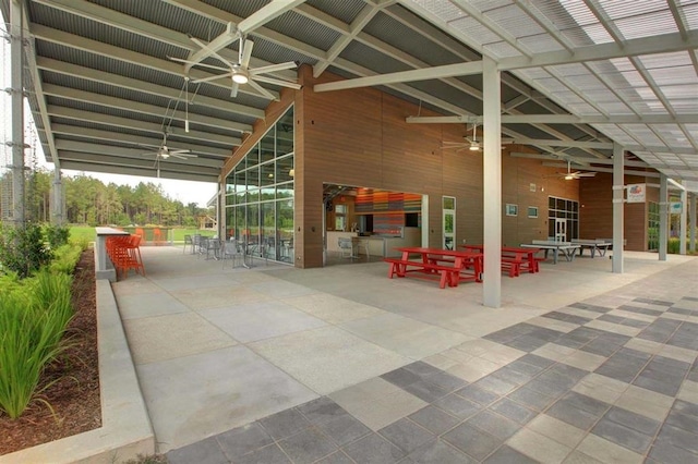 view of patio / terrace featuring a bar, ceiling fan, and outdoor dining area