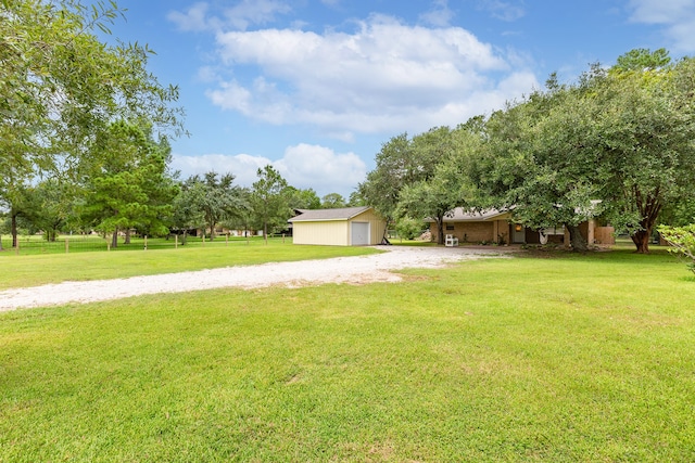 view of yard featuring an outdoor structure and a garage