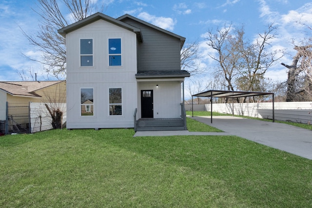 view of front facade with a carport and a front yard