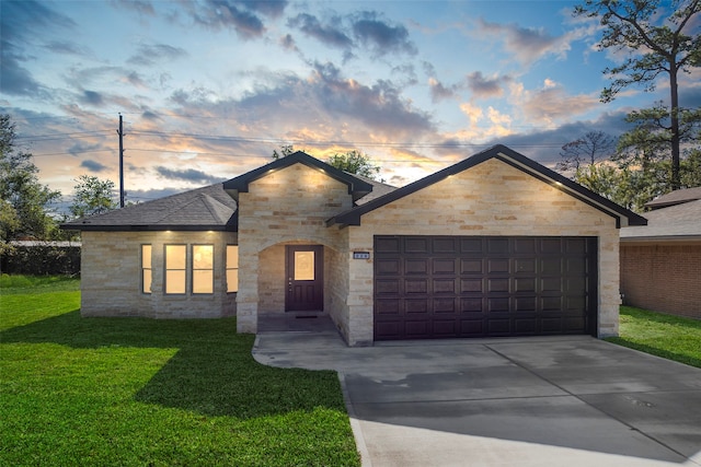 view of front of home featuring a lawn and a garage