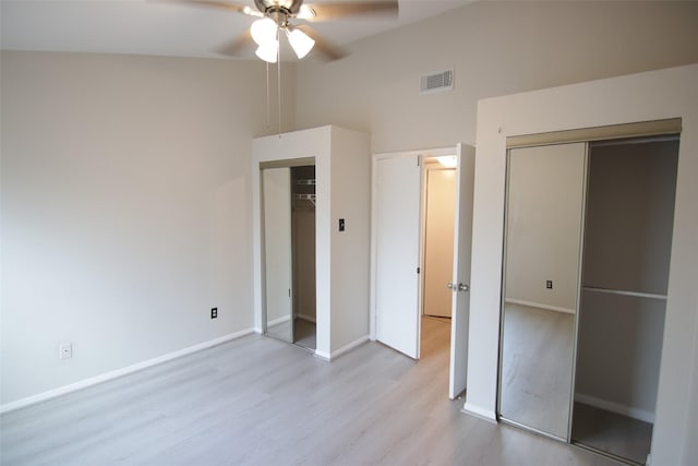 unfurnished bedroom with a closet, ceiling fan, light hardwood / wood-style flooring, and high vaulted ceiling