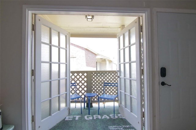 doorway featuring french doors and carpet