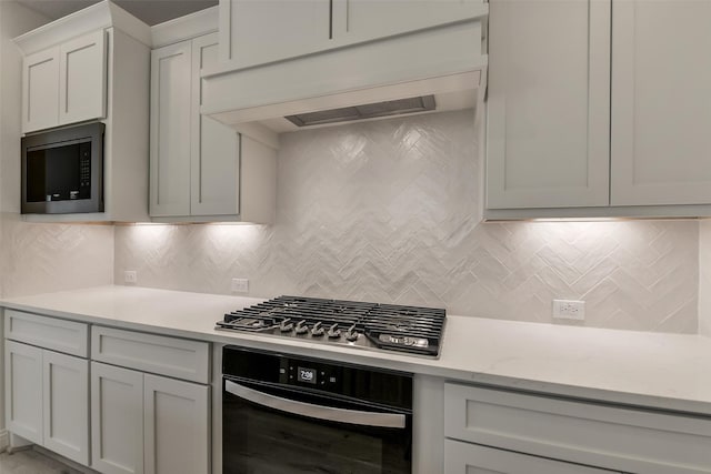 16334 Placid Stream St, Conroe, TX 77302 - kitchen featuring custom exhaust hood, tasteful backsplash, built in microwave, stainless steel gas cooktop, and oven