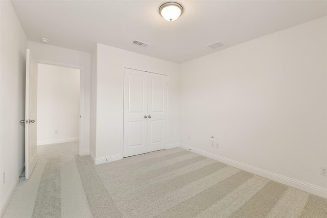 16334 Placid Stream St, Conroe, TX 77302 - unfurnished bedroom featuring baseboards, light carpet, visible vents, and a closet