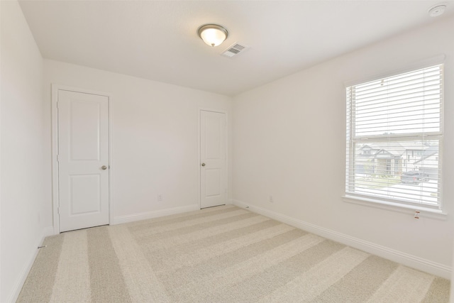 16334 Placid Stream St, Conroe, TX 77302 - spare room with baseboards, visible vents, and light colored carpet