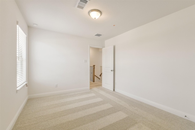 16334 Placid Stream St, Conroe, TX 77302 - spare room with light carpet, visible vents, and baseboards