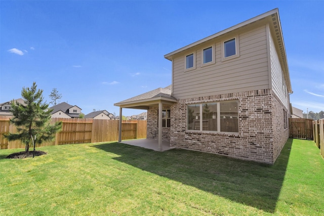 16334 Placid Stream St, Conroe, TX 77302 - back of property featuring brick siding, a patio area, a lawn, and a fenced backyard