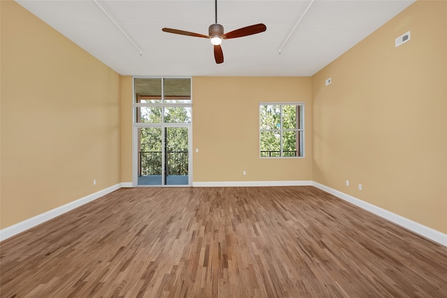 empty room featuring ceiling fan and hardwood / wood-style flooring