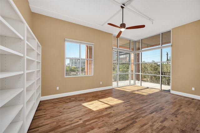 empty room with wood-type flooring and ceiling fan