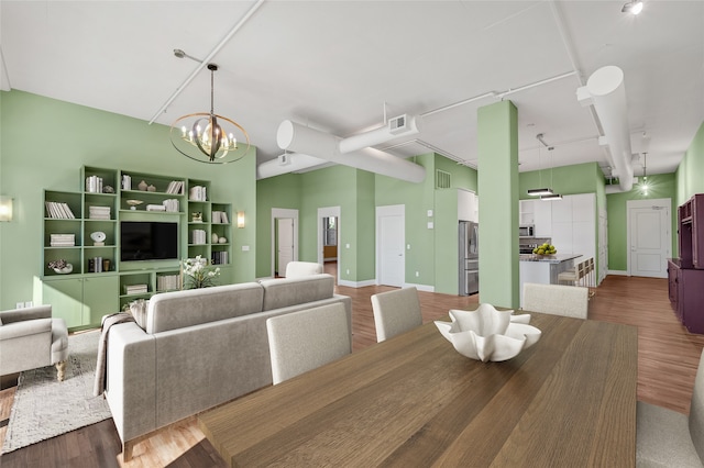 dining area with hardwood / wood-style flooring and a notable chandelier