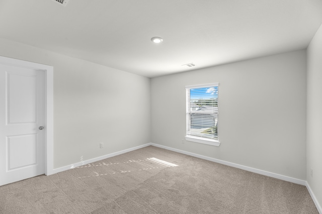 spare room with light colored carpet