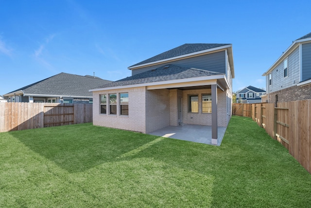 rear view of property featuring a lawn and a patio area