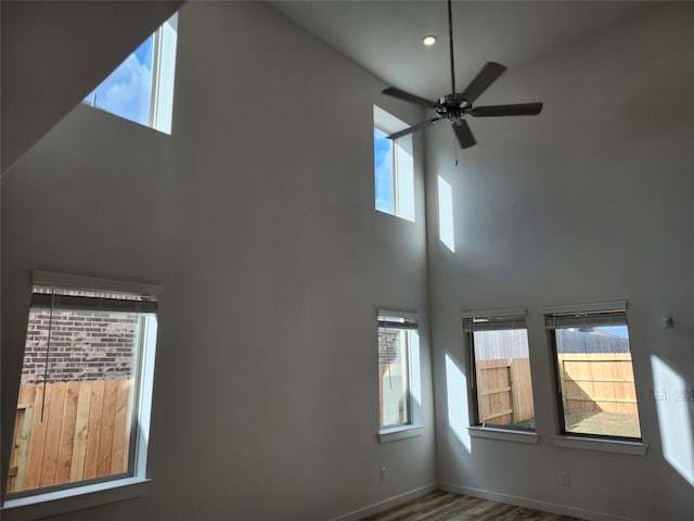 spare room featuring plenty of natural light and a towering ceiling