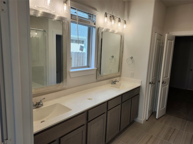 bathroom featuring vanity and a shower with shower door