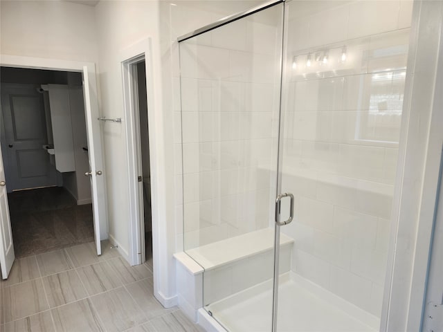 bathroom featuring tile patterned flooring and an enclosed shower