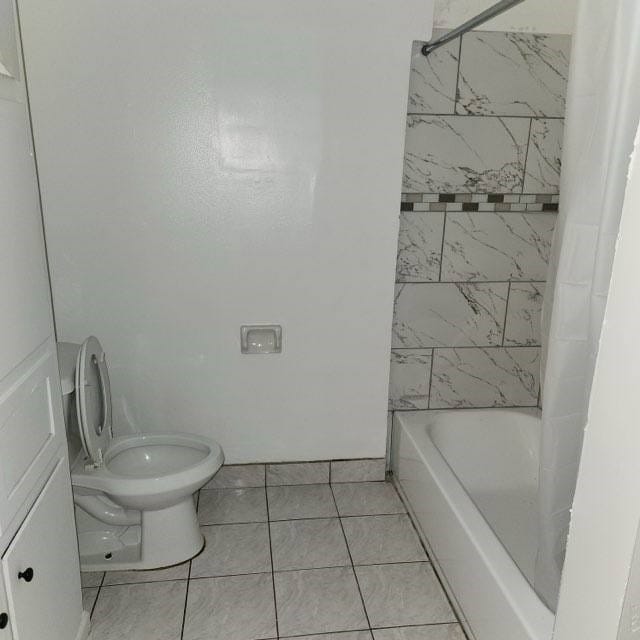 bathroom with tile patterned floors and toilet