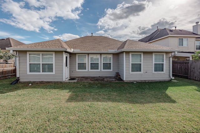 rear view of house with a lawn