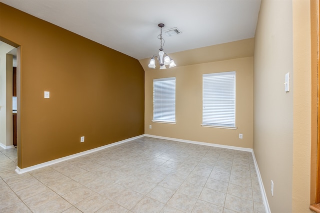 unfurnished room featuring a chandelier and light tile patterned floors