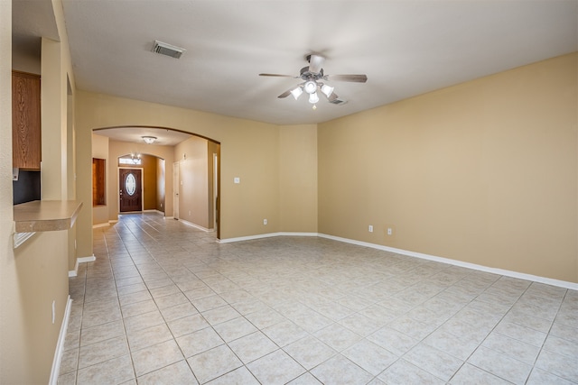 tiled empty room featuring ceiling fan