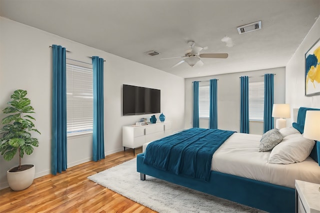 bedroom with light hardwood / wood-style flooring and ceiling fan